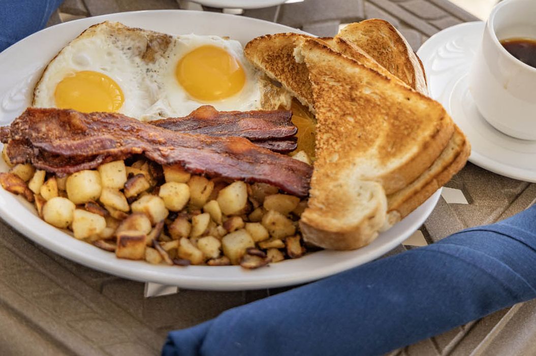A full breakfast including hash browns, eggs, coffee, and toast